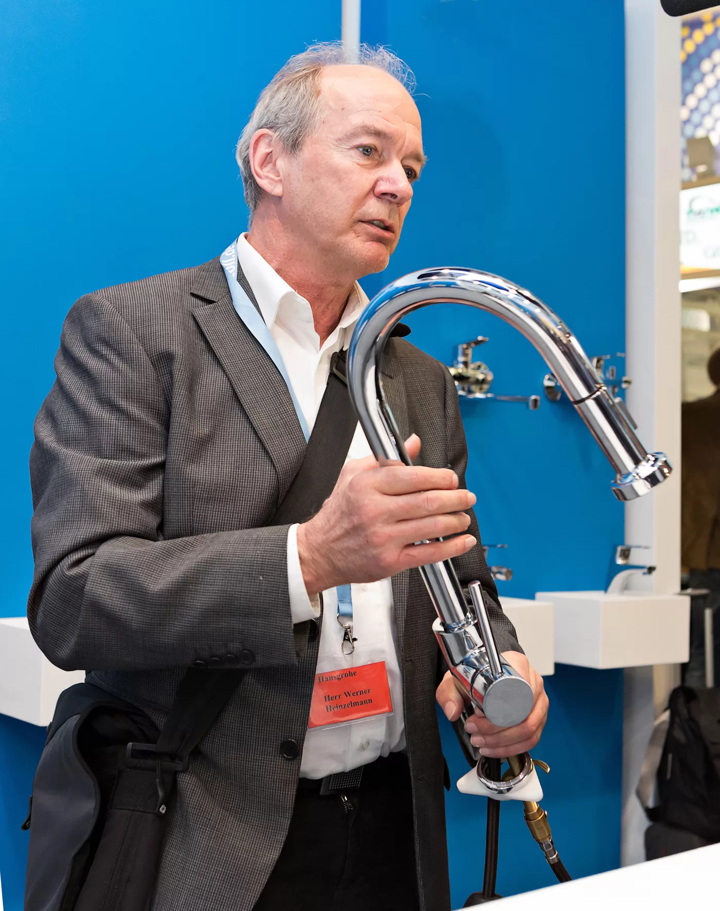 Werner Heinzelmann, Head of the Patents and Intellectual Property Rights division at Hansgrohe SE, removes a pirate copy of a Hansgrohe kitchen mixer from circulation at the ISH trade fair in Frankfurt.